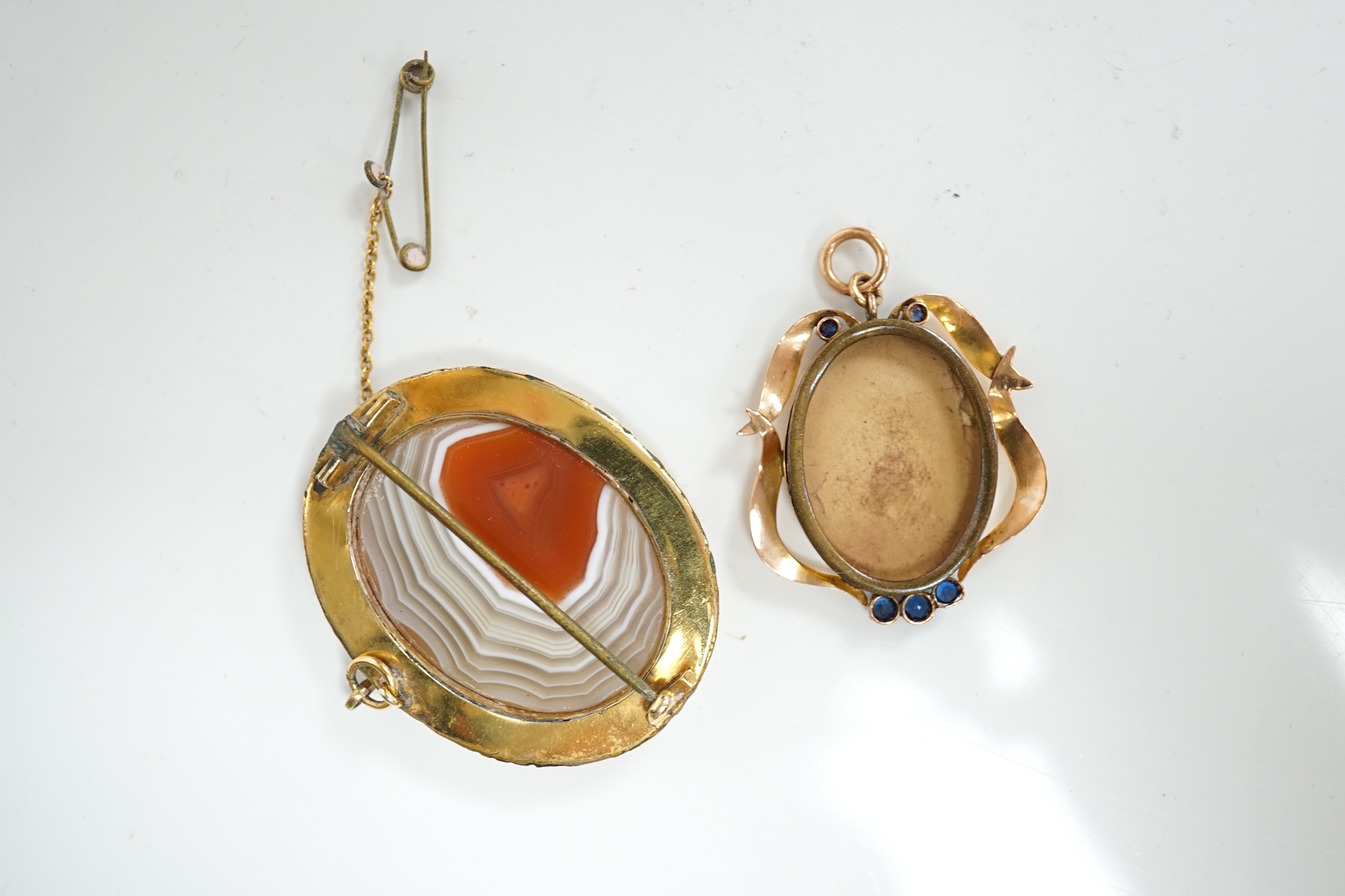 An early 20th century 9ct and gem set oval locket (lacking back?), 32mm, together with a silver mounted golf club hat pin and a mounted agate brooch. Condition - poor to fair